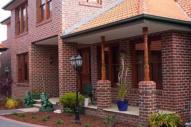 Inspiration for a mid-sized traditional two-storey brick house exterior in Sydney with a tile roof.