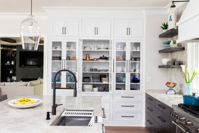 Photo of a large modern u-shaped enclosed kitchen in Raleigh with a built-in sink, recessed-panel cabinets, white cabinets, granite worktops, white splashback, medium hardwood flooring, brown floors and black worktops.