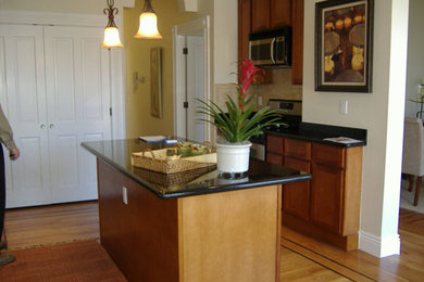 Inspiration for a mid-sized contemporary galley light wood floor open concept kitchen remodel in San Francisco with a double-bowl sink, flat-panel cabinets, light wood cabinets, marble countertops, beige backsplash, ceramic backsplash, stainless steel appliances and an island