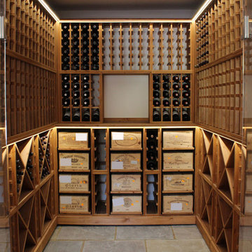 Medium sized wine cellar with glass door opening in West Sussex, UK.