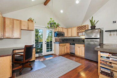 Example of a large u-shaped medium tone wood floor kitchen design in Seattle with a drop-in sink, raised-panel cabinets, light wood cabinets, stainless steel appliances, no island and gray backsplash