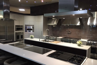 Kitchen - huge contemporary kitchen idea in Kansas City with an undermount sink, flat-panel cabinets, gray cabinets, quartzite countertops, gray backsplash, marble backsplash, stainless steel appliances, an island and white countertops