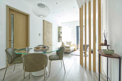 Photo of a medium sized scandi open plan dining room in Manchester with white walls, ceramic flooring, no fireplace and brown floors.