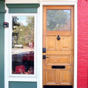 This is an example of an eclectic entryway in Cleveland with a single front door and a light wood front door.