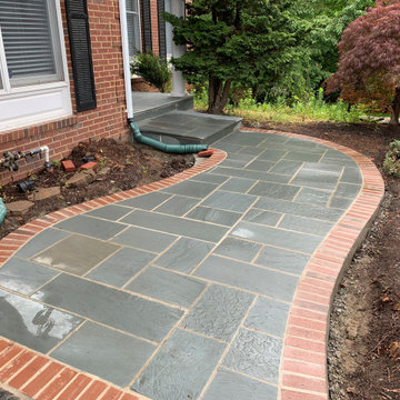 Limestone walkway with brick ascent to match house