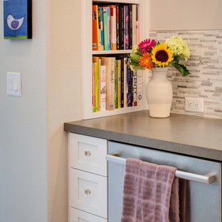 This is an example of a mid-sized contemporary l-shaped kitchen pantry in San Diego with an undermount sink, recessed-panel cabinets, grey cabinets, solid surface benchtops, beige splashback, matchstick tile splashback, stainless steel appliances, porcelain floors, with island, beige floor and white benchtop.