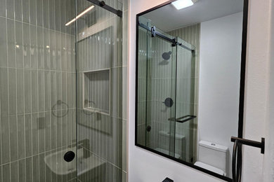 Bathroom - small contemporary master green tile and porcelain tile marble floor, green floor and single-sink bathroom idea in Austin with a one-piece toilet, white walls, a pedestal sink and a niche