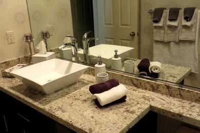 Example of a mid-sized transitional 3/4 brown tile painted wood floor bathroom design in Other with a wall-mount sink, raised-panel cabinets, beige cabinets, laminate countertops, multicolored walls and beige countertops