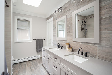 Photo of a contemporary master bathroom in Vancouver with recessed-panel cabinets, white cabinets, an open shower, beige tile, ceramic tile, grey walls, ceramic floors, an undermount sink, engineered quartz benchtops, beige floor, a shower curtain, beige benchtops, a double vanity and a built-in vanity.