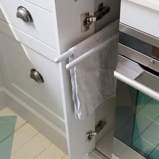 Mid-sized traditional u-shaped kitchen pantry in Sydney with a farmhouse sink, shaker cabinets, grey cabinets, quartz benchtops, white splashback, ceramic splashback, stainless steel appliances, painted wood floors and no island.