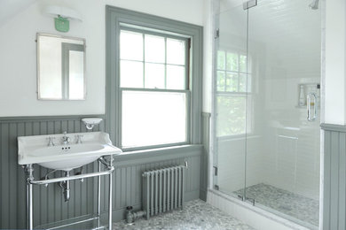 This is an example of a mid-sized traditional 3/4 bathroom in Providence with green cabinets, green walls, a console sink, recessed-panel cabinets, an alcove shower, a two-piece toilet, green tile and marble floors.