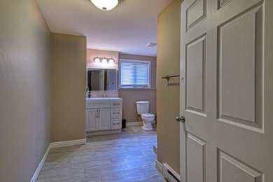 Mid-sized eclectic ceramic tile bathroom photo in Other with glass-front cabinets