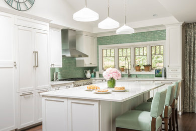 Design ideas for a large transitional l-shaped kitchen in New York with an undermount sink, recessed-panel cabinets, white cabinets, stainless steel benchtops, green splashback, subway tile splashback, stainless steel appliances, dark hardwood floors and with island.