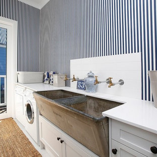 他の地域の小さいカントリー風おしゃれな洗濯室 (エプロンフロントシンク、シェーカースタイル扉のキャビネット、白いキャビネット、マルチカラーの壁、セラミックタイルの床、左右配置の洗濯機・乾燥機、白い床、白いキッチンカウンター) の写真