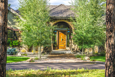 Photo of a large traditional front yard partial sun driveway for fall in Denver with a garden path and brick pavers.