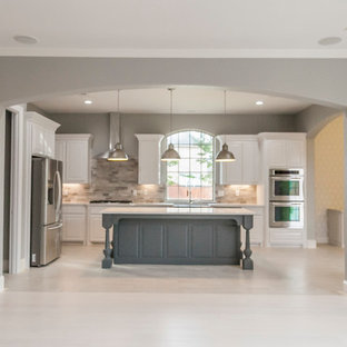 Large modern open concept kitchen designs - Example of a large minimalist single-wall bamboo floor open concept kitchen design in Dallas with a double-bowl sink, louvered cabinets, white cabinets, quartzite countertops, gray backsplash, ceramic backsplash, stainless steel appliances and an island