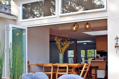 Trendy medium tone wood floor dining room photo in San Francisco with white walls