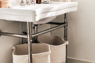 French country bathroom photo in Los Angeles with a console sink