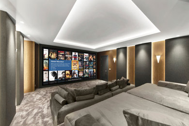 Photo of a contemporary enclosed home cinema in London with grey walls, carpet, a projector screen, grey floors and feature lighting.