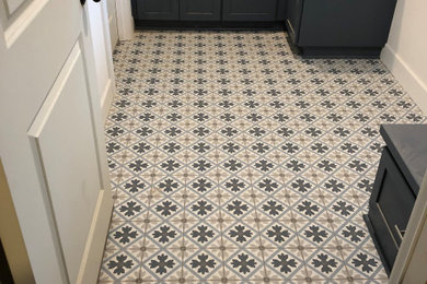 Inspiration for a mid-sized contemporary l-shaped porcelain tile and multicolored floor dedicated laundry room remodel in Portland with shaker cabinets, blue cabinets, quartz countertops, white walls, a side-by-side washer/dryer and white countertops