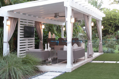 Example of a mid-sized trendy backyard stone patio kitchen design in Miami with a gazebo