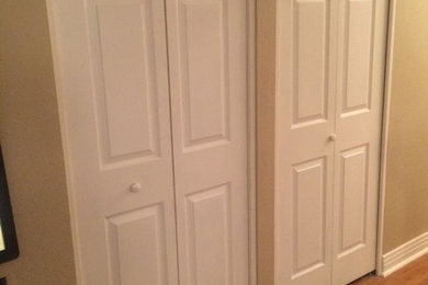 Example of a large classic medium tone wood floor hallway design in Denver with beige walls