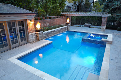 Photo of a mid-sized contemporary backyard rectangular lap pool in Toronto with a hot tub and concrete pavers.