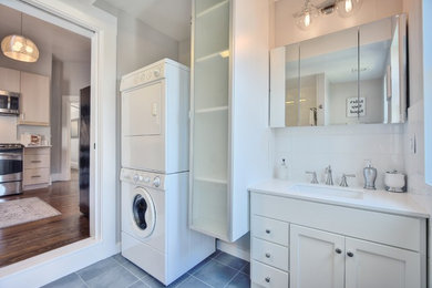 Ornate white tile and ceramic tile porcelain tile and blue floor bathroom photo in San Francisco with a one-piece toilet, white walls, quartz countertops and white countertops