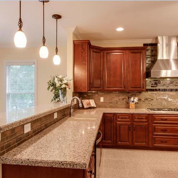 Traditional kitchen with bronze glass backsplash and recycled counter