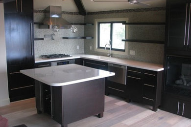 Small minimalist l-shaped light wood floor eat-in kitchen photo in Orange County with an undermount sink, flat-panel cabinets, dark wood cabinets, quartz countertops, metallic backsplash, glass tile backsplash, paneled appliances and an island