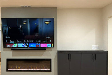 Inspiration for a mid-sized modern medium tone wood floor and orange floor living room remodel in San Francisco with green walls, a hanging fireplace and a wall-mounted tv