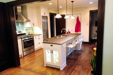 Inspiration for a small timeless single-wall eat-in kitchen remodel in Minneapolis with flat-panel cabinets, white cabinets and an island