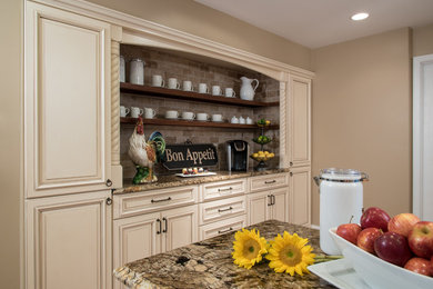 Mid-sized transitional l-shaped light wood floor eat-in kitchen photo in St Louis with a single-bowl sink, raised-panel cabinets, white cabinets, granite countertops, beige backsplash, subway tile backsplash, stainless steel appliances and an island