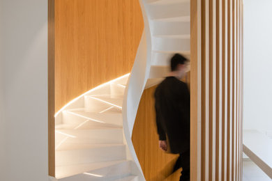 Design ideas for a large modern wood railing staircase in Other with marble treads.