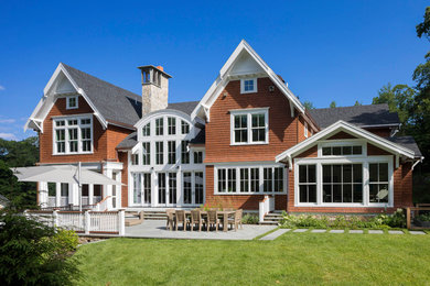 Inspiration for a large timeless brown two-story wood exterior home remodel in Boston with a shingle roof