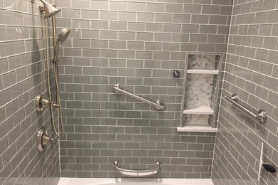 Example of a mid-sized trendy 3/4 green tile and glass tile marble floor freestanding bathtub design in Chicago with flat-panel cabinets, white cabinets and an undermount sink