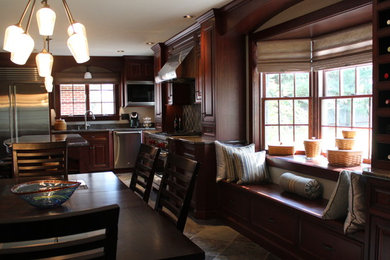 Huge elegant l-shaped slate floor and multicolored floor eat-in kitchen photo in Philadelphia with an undermount sink, raised-panel cabinets, dark wood cabinets, granite countertops, multicolored backsplash, stone tile backsplash, stainless steel appliances and an island