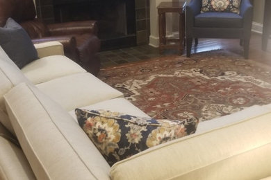 Large elegant open concept vaulted ceiling family room photo in Chicago with a standard fireplace, a wood fireplace surround and a media wall