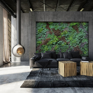 Immagine di un soggiorno moderno di medie dimensioni e stile loft con sala formale, pareti grigie, pavimento in cemento, camino sospeso, cornice del camino in cemento, nessuna TV e pavimento grigio