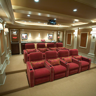 Home theater - large traditional enclosed carpeted and beige floor home theater idea in Grand Rapids with brown walls and a projector screen