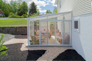 Inspiration for a large timeless backyard gravel patio remodel in Philadelphia with a pergola