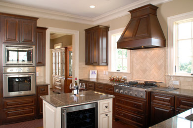 Open concept kitchen - large traditional u-shaped dark wood floor open concept kitchen idea in Atlanta with beaded inset cabinets, dark wood cabinets, granite countertops, beige backsplash, ceramic backsplash, stainless steel appliances, an island and an undermount sink