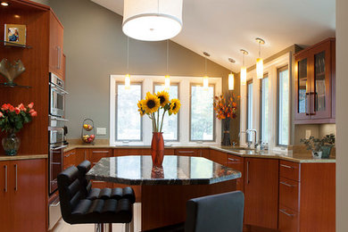 Eat-in kitchen - mid-sized contemporary u-shaped eat-in kitchen idea in Cleveland with flat-panel cabinets, dark wood cabinets, stainless steel appliances and an island