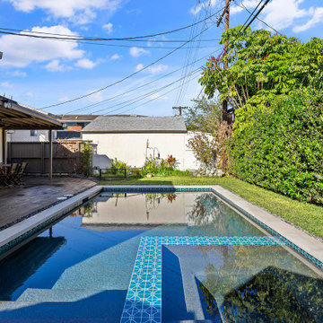 Modern black pebble pool & spa | small backyard
