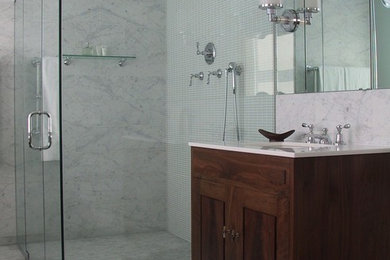 Design ideas for a large transitional master bathroom in New York with an undermount sink, furniture-like cabinets, dark wood cabinets, marble benchtops, a curbless shower, a two-piece toilet, gray tile, stone tile, white walls, marble floors, grey floor and a hinged shower door.