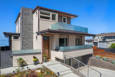 Photo of a mid-sized beach style two-storey beige house exterior in San Francisco.