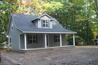 Photo of a small traditional two-storey grey exterior in Other with vinyl siding.