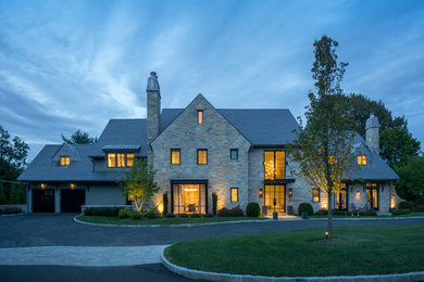 Inspiration for a large eclectic gray two-story stone house exterior remodel in New York
