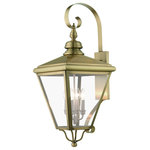 Livex Lighting Inc. - 4 Light Antique Brass Outdoor Extra Large Wall Lantern, Brushed Nickel Cluster - The stylish antique brass finish outdoor Adams extra large wall lantern is a great way to update your home's exterior decor. A flat metal curved arm attaches the solid brass decorative housing to the square backplate while clear glass shows off the brushed nickel finish cluster.