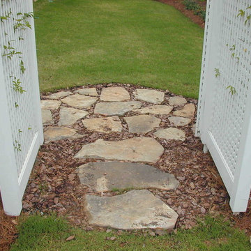 Natural stepping stone path under arbor & thru gate